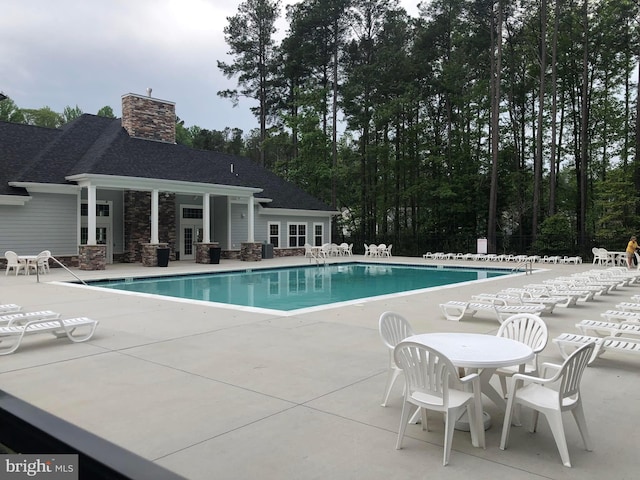 pool featuring a patio area, fence, and french doors