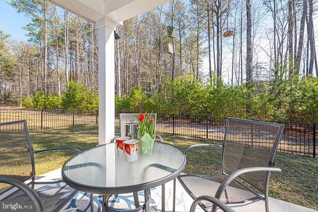 view of patio featuring outdoor dining space and fence