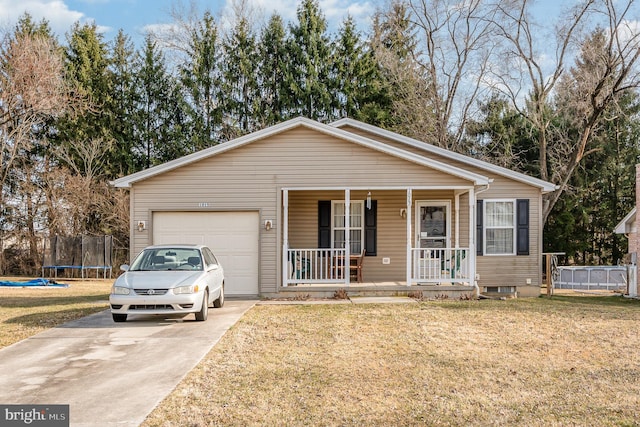 view of front of home featuring a trampoline, covered porch, concrete driveway, a front yard, and a garage