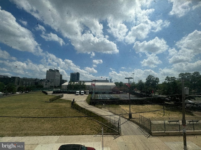 view of community featuring a view of city and fence