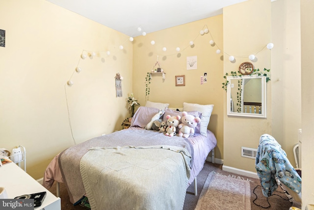 bedroom with carpet floors, visible vents, and baseboards