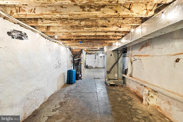 unfinished basement featuring heating unit