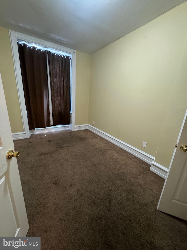 spare room with carpet floors and baseboards