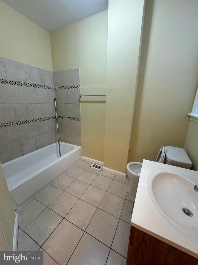 full bath with tile patterned flooring, a bathing tub, toilet, visible vents, and vanity