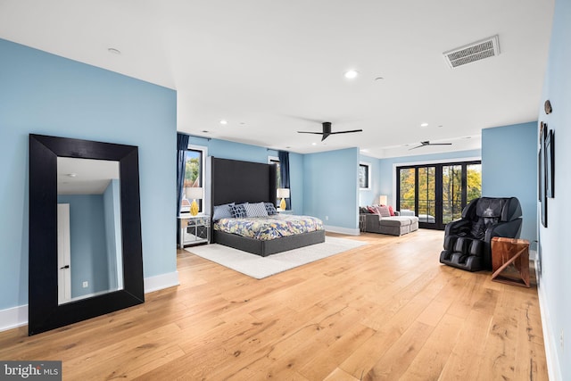 bedroom with access to outside, french doors, visible vents, and hardwood / wood-style flooring