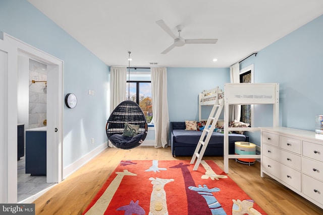 bedroom featuring baseboards, recessed lighting, connected bathroom, and light wood-style floors