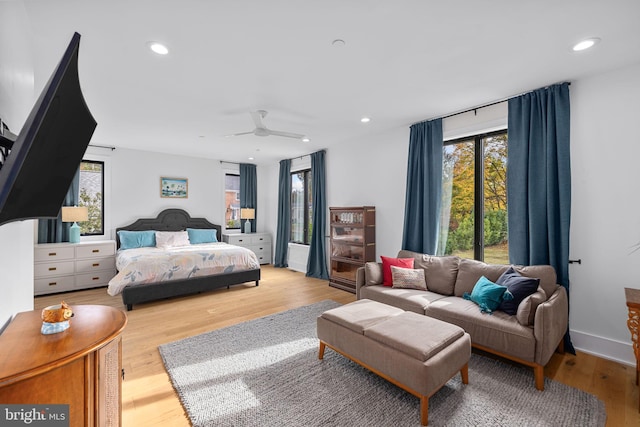 bedroom with ceiling fan, multiple windows, wood finished floors, and recessed lighting