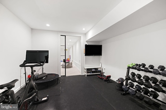 exercise area with baseboards and recessed lighting