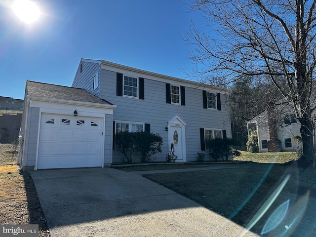 colonial house with a garage and concrete driveway