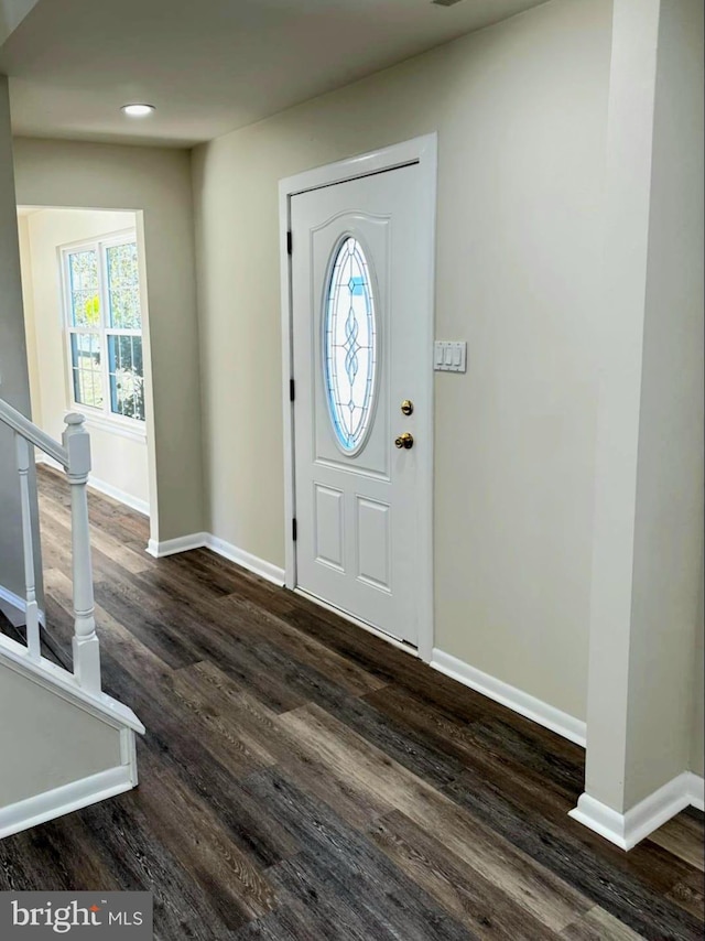 foyer with stairway, baseboards, dark wood finished floors, and recessed lighting