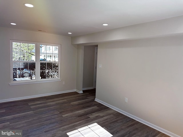 unfurnished room featuring dark wood-style floors, recessed lighting, visible vents, and baseboards