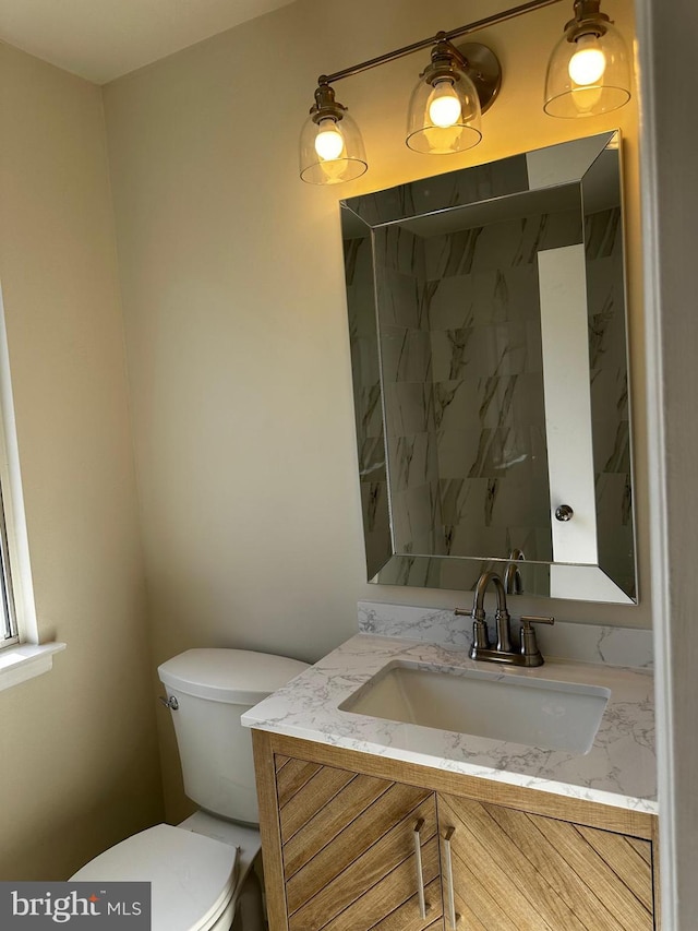 bathroom with vanity and toilet