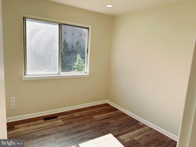 spare room with recessed lighting, visible vents, baseboards, and wood finished floors