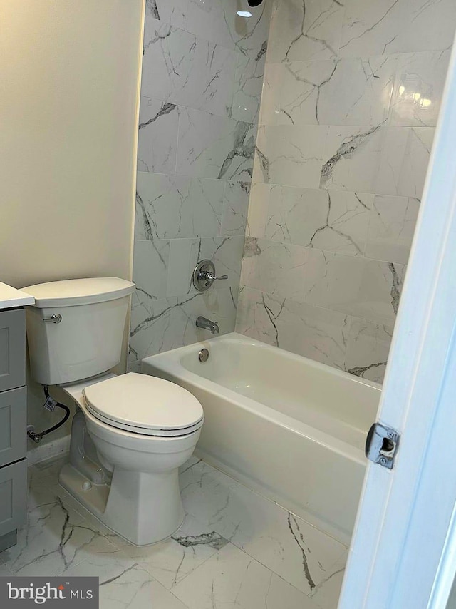 bathroom featuring marble finish floor, shower / bath combination, vanity, and toilet