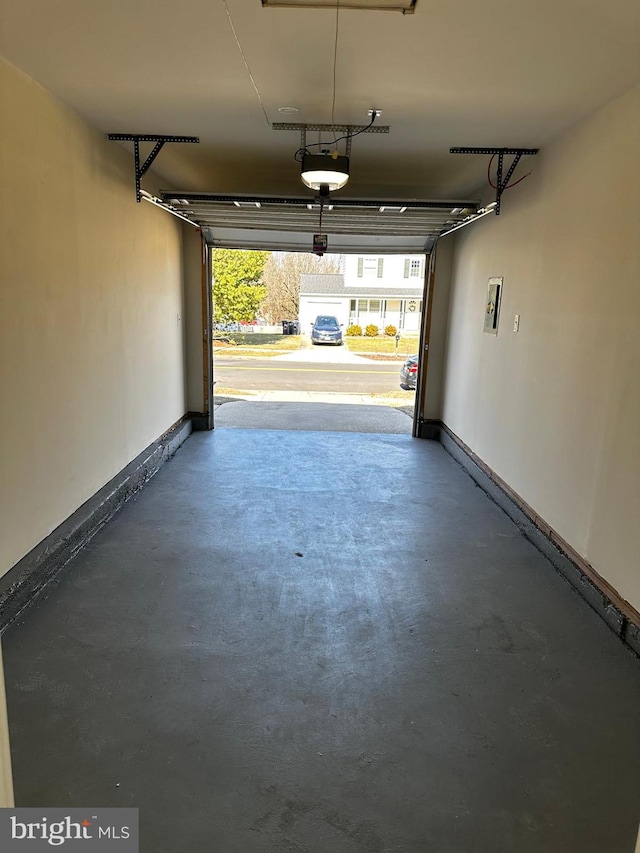 garage featuring baseboards and a garage door opener