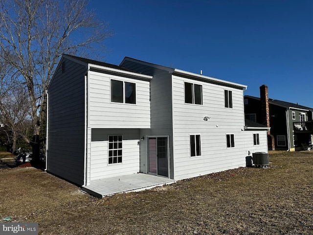 rear view of property with cooling unit