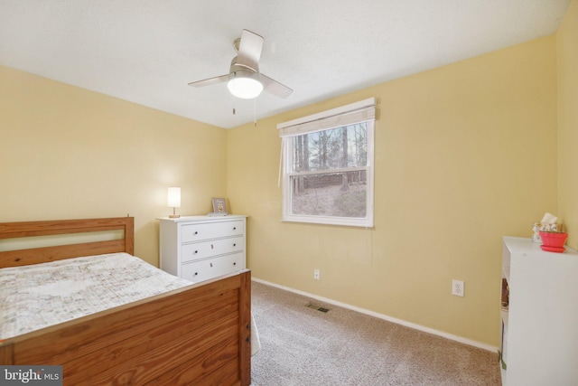 unfurnished bedroom featuring a ceiling fan, carpet flooring, visible vents, and baseboards