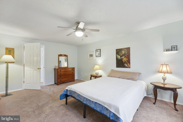 carpeted bedroom featuring ceiling fan and baseboards