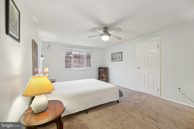 carpeted bedroom featuring a ceiling fan and baseboards