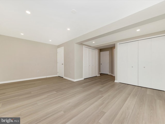 below grade area with baseboards, light wood finished floors, and recessed lighting