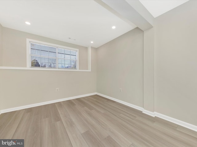 unfurnished room with light wood-type flooring, baseboards, and recessed lighting