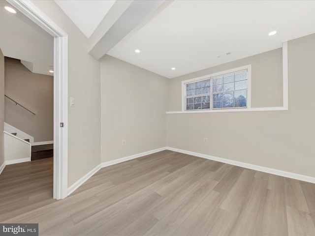 empty room with baseboards, wood finished floors, and recessed lighting