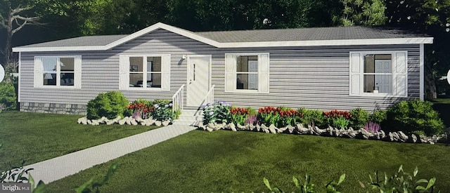 manufactured / mobile home with entry steps and a front yard