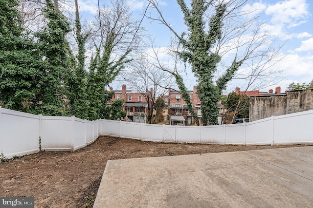 view of yard with a fenced backyard and a residential view