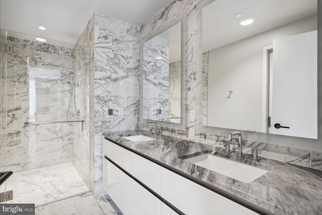 full bathroom featuring double vanity, a marble finish shower, a sink, and recessed lighting