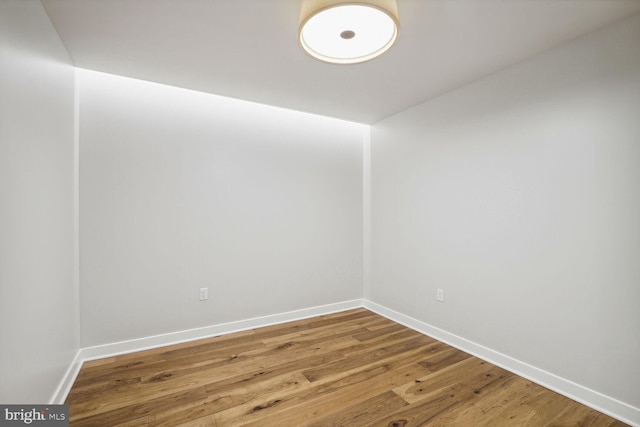 unfurnished room featuring wood finished floors and baseboards