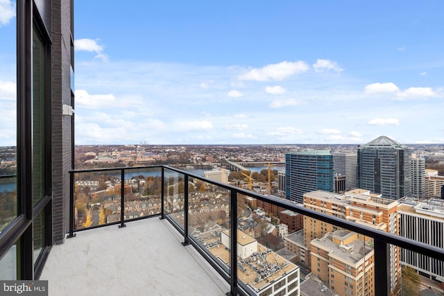 balcony featuring a water view and a view of city