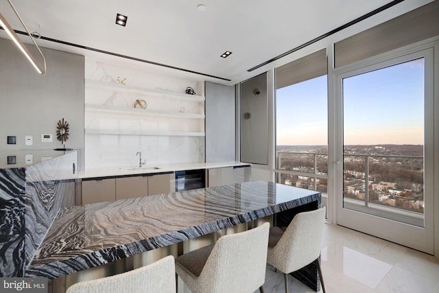 dining area featuring beverage cooler, marble finish floor, and indoor wet bar