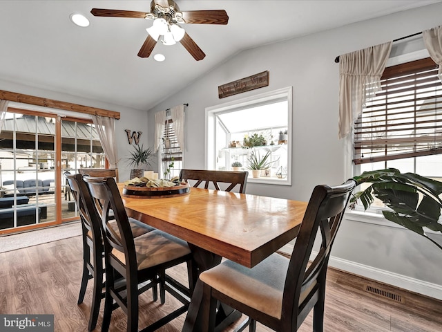 dining room with lofted ceiling, recessed lighting, wood finished floors, visible vents, and baseboards