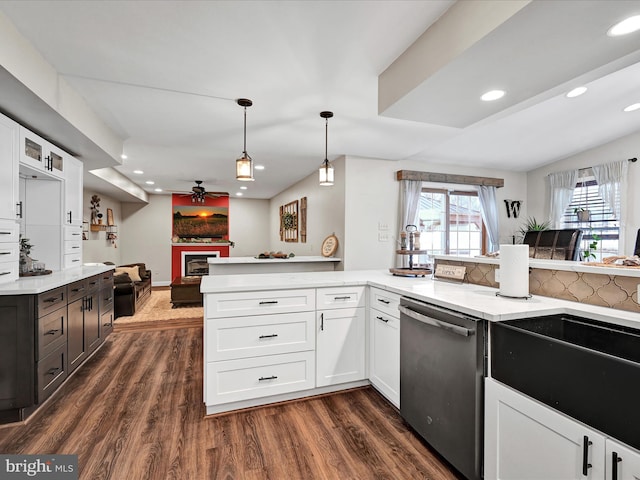 kitchen featuring dark wood-style floors, white cabinetry, a fireplace, and stainless steel dishwasher