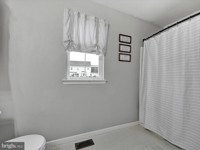 bathroom with visible vents, toilet, and baseboards