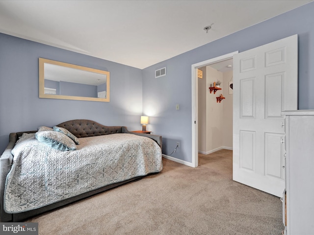 carpeted bedroom with visible vents and baseboards