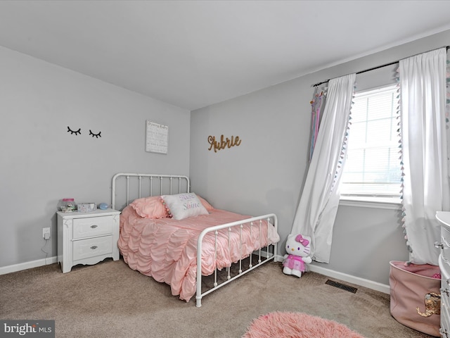 carpeted bedroom featuring visible vents and baseboards