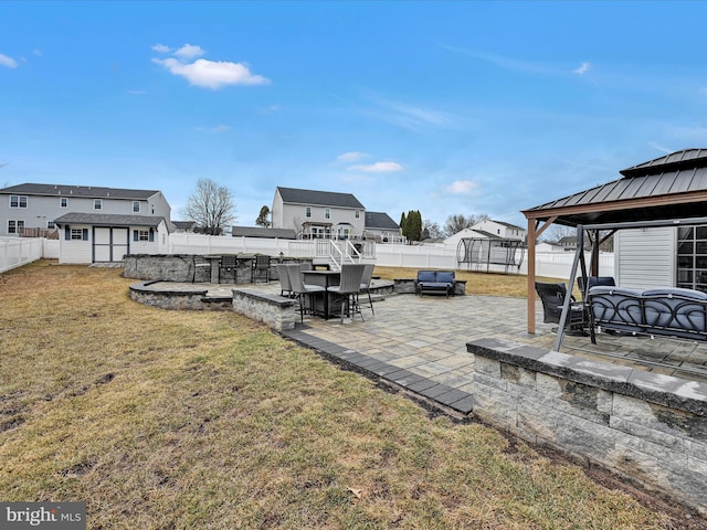 view of yard with a patio, a fenced backyard, a storage unit, a gazebo, and an outdoor structure