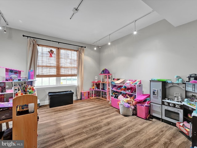 game room with track lighting and wood finished floors