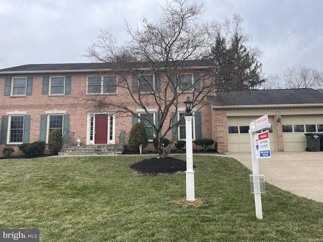 colonial home featuring a front lawn, brick siding, driveway, and an attached garage