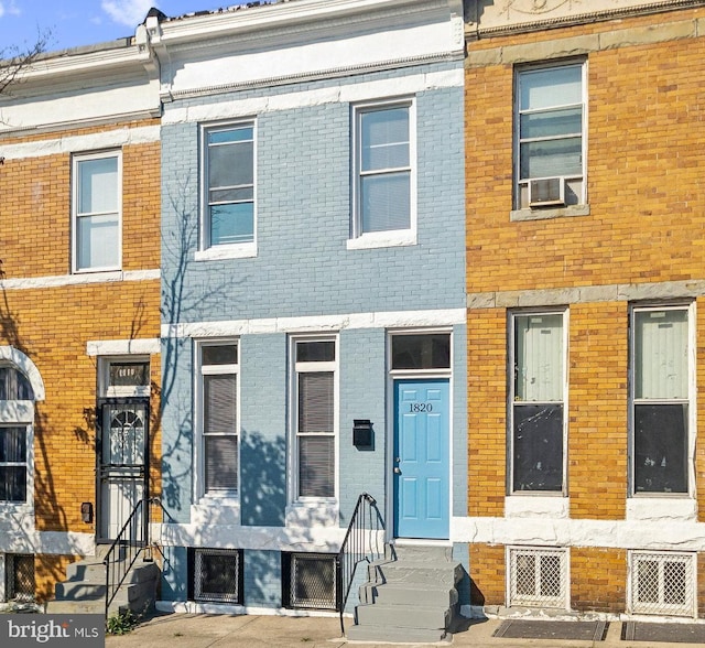 multi unit property featuring entry steps and brick siding