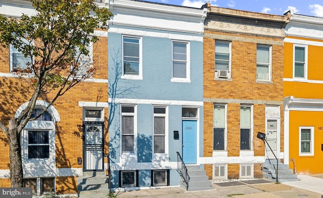 townhome / multi-family property featuring entry steps and brick siding