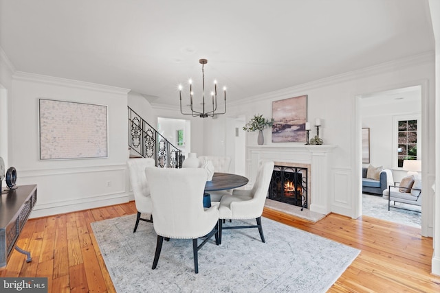 506 Ivy Cir, Alexandria, VA 22302 - dining area with light wood-style floors, stairway, a notable chandelier, and crown molding