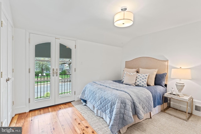 506 Ivy Cir, Alexandria, VA 22302 - bedroom featuring access to outside, french doors, vaulted ceiling, and hardwood / wood-style flooring