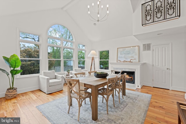 506 Ivy Cir, Alexandria, VA 22302 - dining area with a wealth of natural light, a high end fireplace, hardwood / wood-style flooring, and beamed ceiling