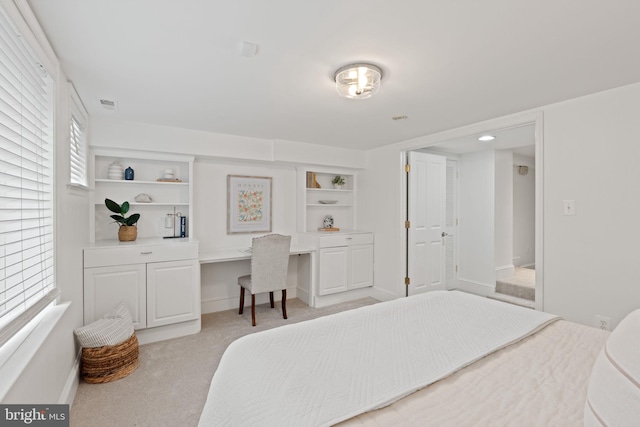 506 Ivy Cir, Alexandria, VA 22302 - bedroom featuring built in desk, light colored carpet, baseboards, and visible vents