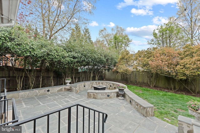 506 Ivy Cir, Alexandria, VA 22302 - view of patio / terrace with a fire pit and a fenced backyard