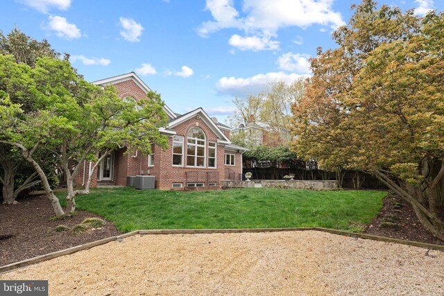506 Ivy Cir, Alexandria, VA 22302 - rear view of property featuring a lawn, brick siding, fence, and central AC unit