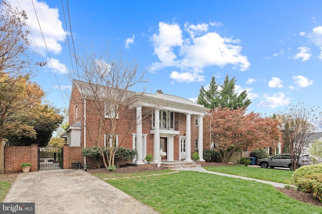 506 Ivy Cir, Alexandria, VA 22302 - neoclassical / greek revival house featuring brick siding, a front lawn, fence, and a gate