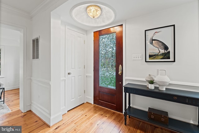 506 Ivy Cir, Alexandria, VA 22302 - foyer entrance with crown molding, visible vents, and light wood finished floors